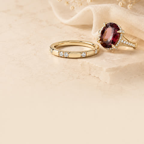 A ruby ring and diamond band arranged as a meaningful gift.