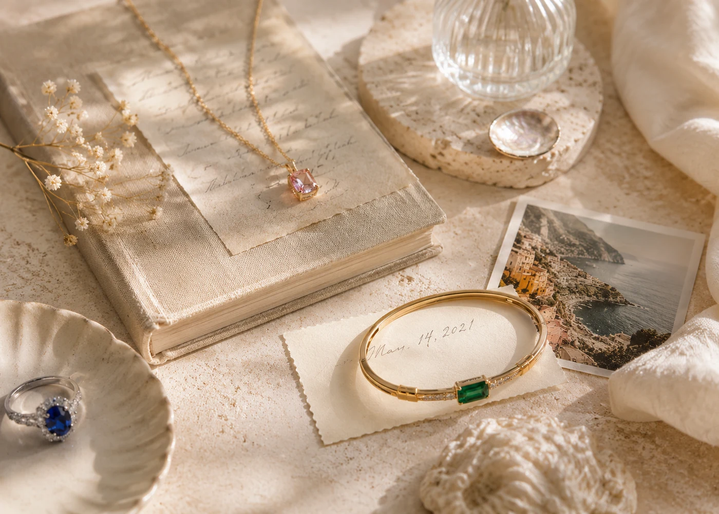 Personal jewelry, a travel photograph, an old book, and a handwritten summer memory.