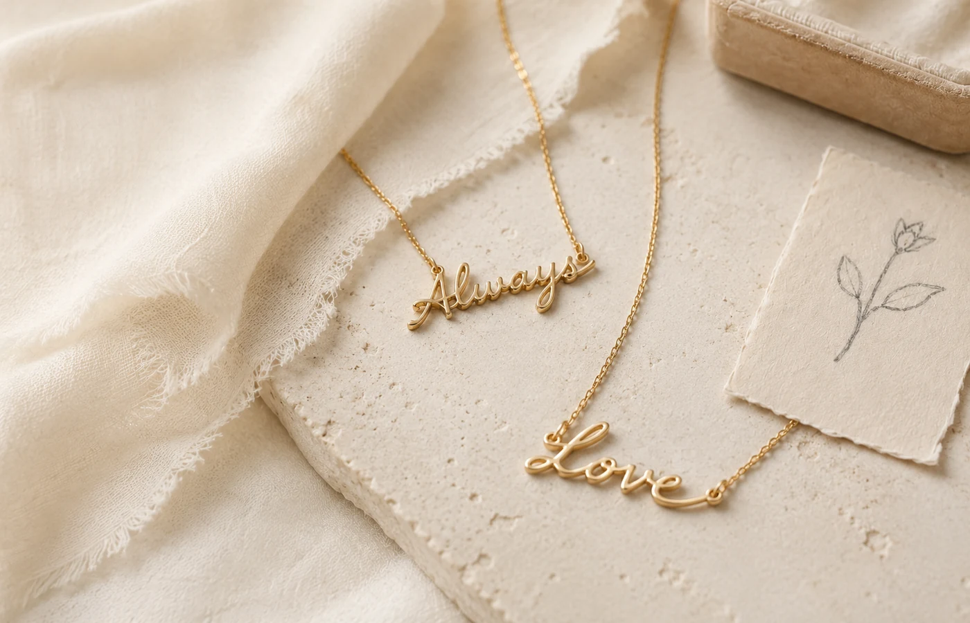 Two gold name necklaces shaped from personal handwriting.